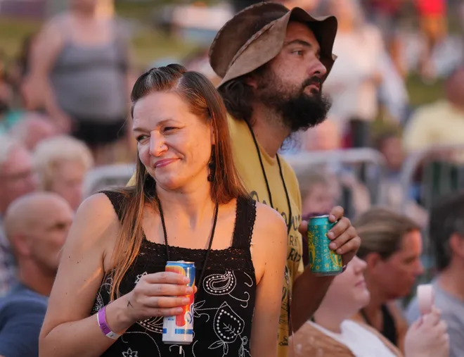 Liz Colvin, left, and her boyfriend Kyle Hodapp, dance as Old Crow Medicine Show band members perform at the Rebich Investments Amphitheater in Erie, Pa., on Aug. 5, 2026.