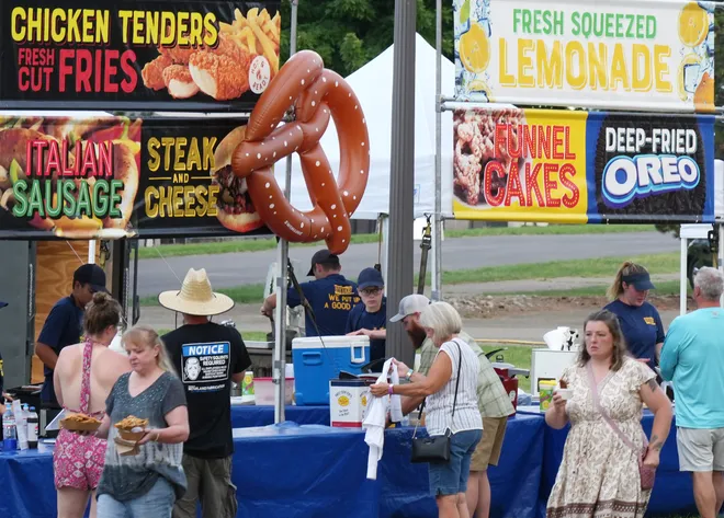People visit food trucks before Old Crow Medicine Show performs at the Rebich Investments Amphitheater in Erie, Pa., on Aug. 5, 2026. You might also enjoy More big-name concerts in Erie history