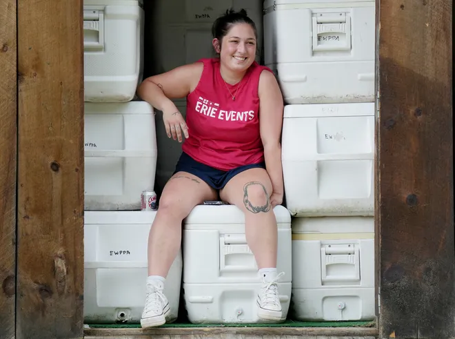 Erie Events Supervisor Kaincie Pesta, 26, takes a break prior to Old Crow Medicine Show performing at the Rebich Investments Amphitheater in Erie, Pa., on Aug. 5, 2026.