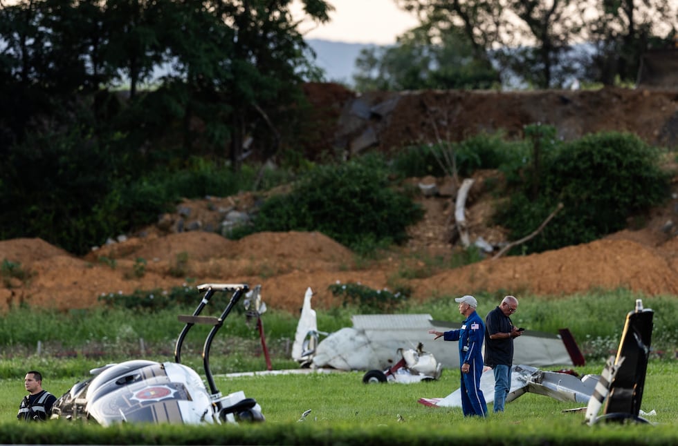 Authorities investigate a crash between a Pennsylvania State Police helicopter and a small...