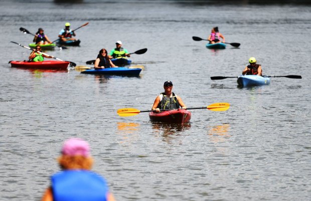Kayakers on the Susquehanna River paddle toward the Nesbitt Park boat launch in Wilkes-Barre during the Riverfront Parks Committee's Wyoming Valley Riverfest in July 2021. (The Citizens' Voice file)
