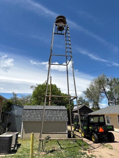 The siren tower stands behind the old Erie Town Hall building, now home to the Chamber of Commerce. The tower was removed Monday and the siren will be preserved. (Courtesy photo / town of Erie)