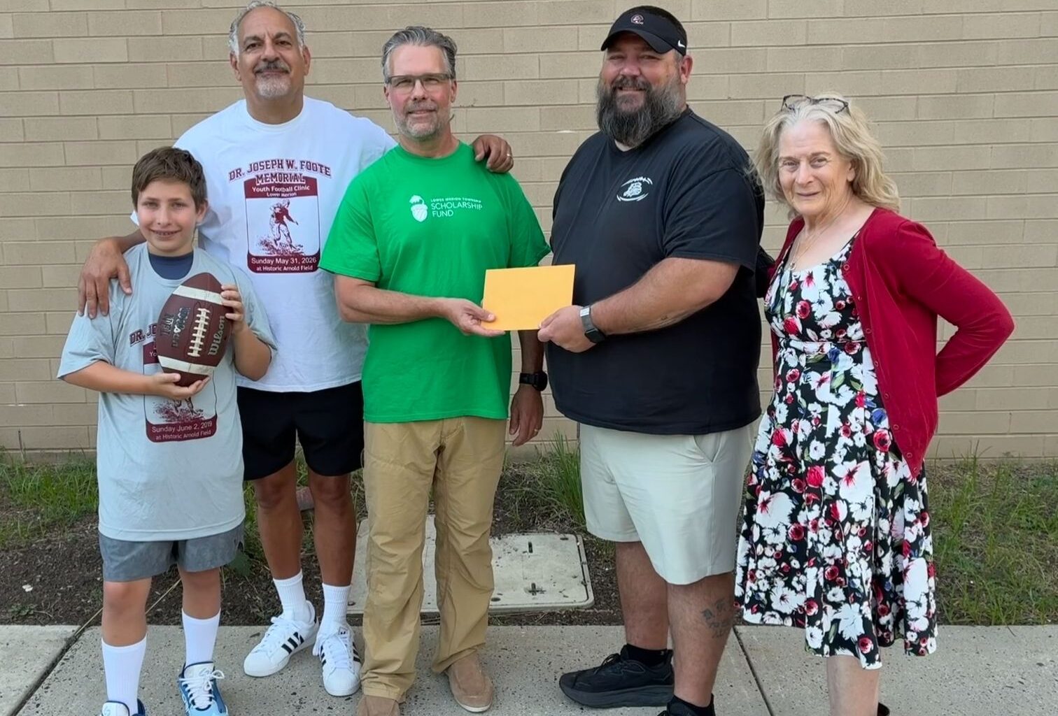 Lower Merion ‘Bulldogs’ Youth Football clinic handoff of proceeds to LM Township scholarship fund