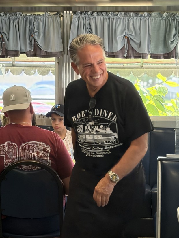 Jim Evans works the Saturday morning crowd like a pro. (Photo courtesy of John Katrina)