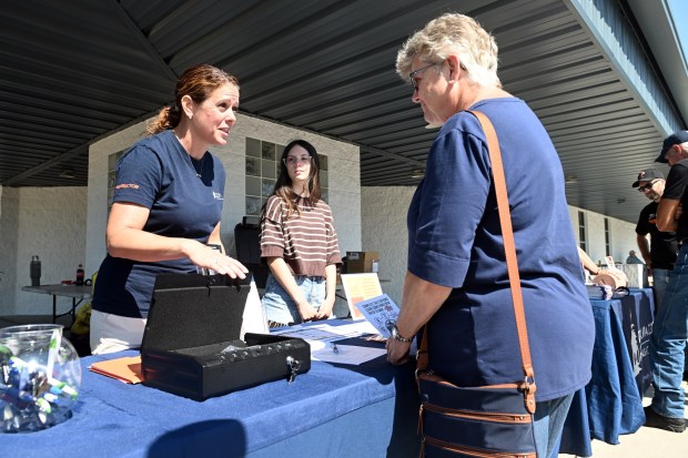 Teena Lee, violence recovery program manager at Reading Hospital, explains the use of a handgun safe during a motorcycle safety event sponsored by Reading Hospital at Classic Harley Davidson in Bern Township on Saturday, Aug. 29, 2026.  (BILL UHRICH/READING EAGLE)