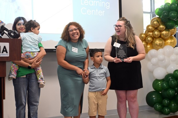 Yessenia Vasquez, center, director of child care at the Patton Avenue Learning Center, receives an award during ceremonies honoring the center's STAR 4 achievement on Monday, Aug. 17, 2026. (BILL UHRICH/READING EAGLE)