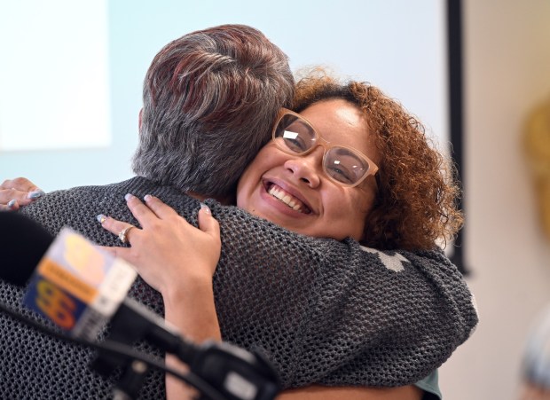 Yessenia Vasquez, director of child care at the Patton Avenue Learning Center, hugs Tammy White, president of the United Way of Berks County, after receiving a $10,000 donation during ceremonies honoring the center's STAR 4 achievement on Monday, Aug. 17, 2026. (BILL UHRICH/READING EAGLE)