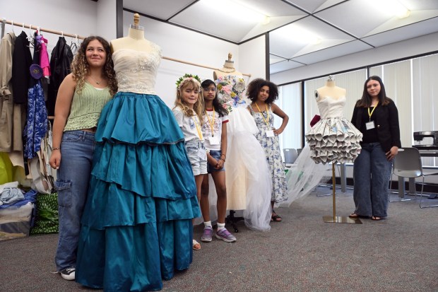 From left, Natalie Poe, 13, an eighth grader at Wilson Southern Middle School; Charlotte Hill, 10, a fifth grader at Cornwall Terrace Elementary School; Cherub Tixeira, 11, a sixth grader at St Ignatius Loyola; Novalee Raser, 13, and eighth grader at Wilson Southern; Sarai Martinez Najarro, 17, a senior at Reading High, display their creations during Alvernia University's Total Learning Experience Fashion and Sustainability Camp. (BILL UHRICH/READING EAGLE)