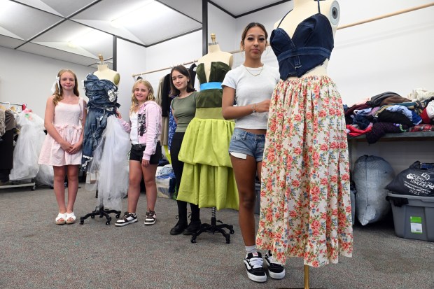 From left, sisters Grace, 11, and Hope, 10, McCalicher, sixth and fifth graders at Gov. Mifflin Intermediate; Estelle Machuzick, 15, a sophomore at Wilson; Emily Hossecker, a freshman at Wyomissing, display their creations during Alvernia University's Total Learning Experience Fashion and Sustainability Camp. (BILL UHRICH/READING EAGLE)