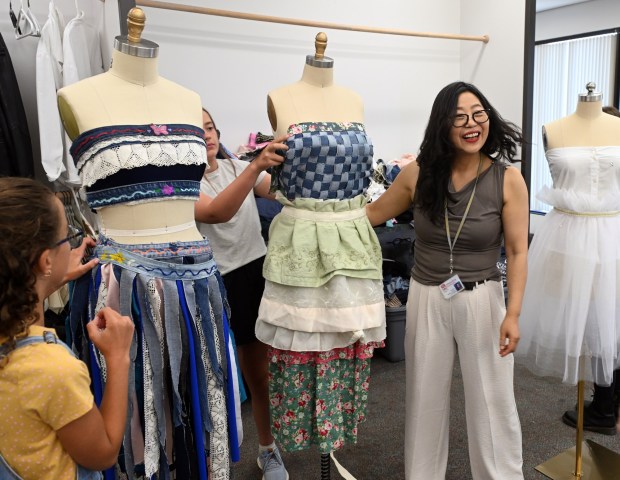 MeeAe Oh-Rank, director of the Fashion Sustainability Camp program at Alvernia University's Total Learning Experience in the College Towne campus, helps students realize their fashion ideas. (BILL UHRICH/READING EAGLE)