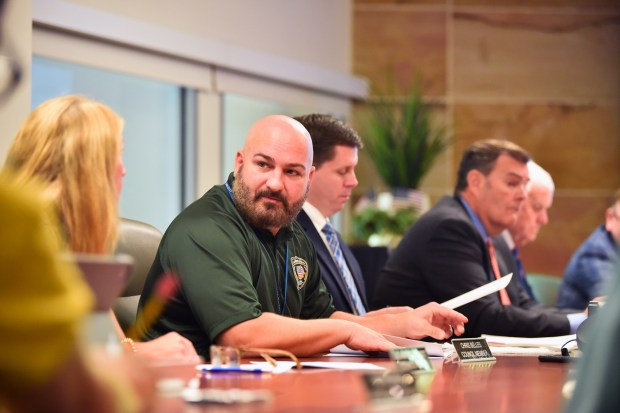 Board member Chris Belles confers with fellow board members during the board meeting in the conference room at the Wilkes-Barre/Scranton International Airport in Pittston Twp. Thursday, August 27, 2026. (SEAN MCKEAG / STAFF PHOTOGRAPHER)