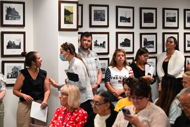 People stand against the wall during the commissioners' meeting held at the county government center in Scranton Wednesday, August 5, 2026. (SEAN MCKEAG / STAFF PHOTOGRAPHER)