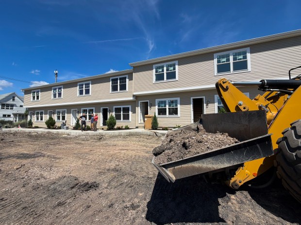 A contruction vehicle sits in front of new townhouses being built on Wheeler Avenue in Scranton Wednesday, August 26, 2026. (SEAN MCKEAG / STAFF PHOTOGRAPHER)