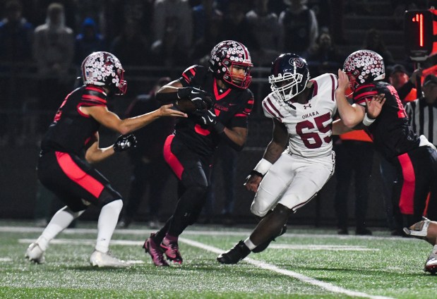North Pocono quarterback Chase Zimmerman hands off the ball to running back Josiah Gray during the 4A quarterfinal game against Cardinal O'Hara at Zephyr Stadium in Whitehall Twp. Friday, November 21, 2025. (SEAN MCKEAG / STAFF PHOTOGRAPHER)
