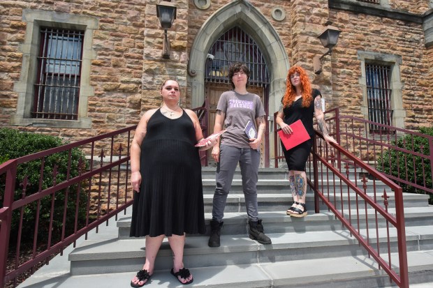 Former inmate Leslie Smith, with writing teachers Maggie Craig and Allison Horrocks stand at the entrance of the Lackawanna County Prison in Scranton Thursday, July 30, 2026. (SEAN MCKEAG / STAFF PHOTOGRAPHER)