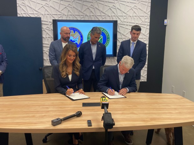 Kelly Loeffler, administrator of the U.S. Small Business Administration and U.S. Secretary of Energy Chris Wright sign a Memorandum of Agreement establishing the Small Business Investment Company-Energy Initiative at Creative Design and Machining Inc. in South Abington Twp. Monday, Aug. 24, 2026. Looking on behind them are, from left, Creative Design and Machining Inc. President Layne Crothers, and U.S. Reps. Dan Meuser, R-9, Jackson Twp. and Rob Bresnahan, R-8, Dallas Twp. (Christine Lee/Staff Photo)
