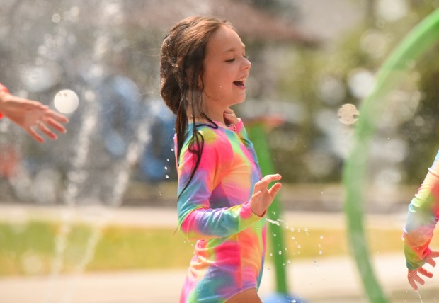 Penny Pratt, 8, of Scranton, enjoys the new Capouse Avenue Park splash pad in Scranton Thursday, August 13, 2026. (SEAN MCKEAG / STAFF PHOTOGRAPHER)