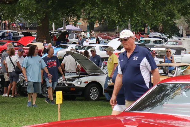 People walk through and inspect rows of cars Sunday, Aug. 2, 2026, at the 63rd annual Das Awkscht Fescht antique and classic car show at Macungie Memorial Park in Macungie. (Jon Chiu/The Morning Call