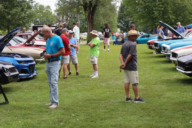 People walk through and inspect rows of cars Sunday, Aug. 2, 2026, at the 63rd annual Das Awkscht Fescht antique and classic car show at Macungie Memorial Park in Macungie. (Jon Chiu/The Morning Call