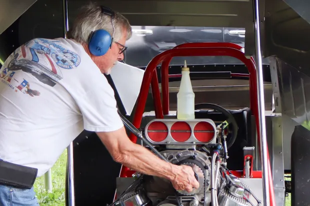 Tom Kauffman works on the engine of Bruce Larson's USA-1 Chevrolet Camaro on Sunday, Aug. 2, 2026, at the 63rd annual Das Awkscht Fescht antique and classic car show at Macungie Memorial Park in Macungie. (Jon Chiu/The Morning Call)