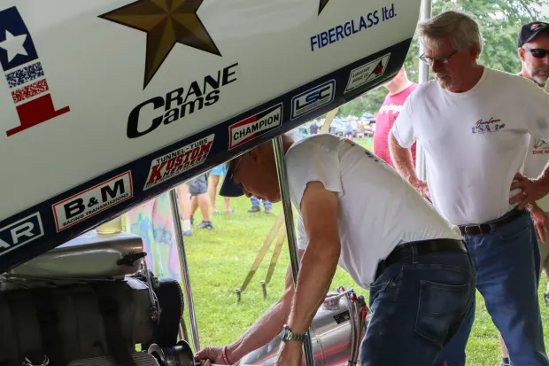 Bruce Larson and Tom Kauffman work on Larson's USA-1 Chevrolet Camaro on Sunday, Aug. 2, 2026, at the 63rd annual Das Awkscht Fescht antique and classic car show at Macungie Memorial Park in Macungie. (Jon Chiu/The Morning Call)