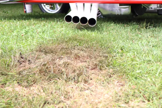 Grass is left scorched from the exhaust of Bruce Larson's Chevrolet Camaro on Sunday, Aug. 2, 2026, at the 63rd annual Das Awkscht Fescht antique and classic car show at Macungie Memorial Park in Macungie. (Jon Chiu/The Morning Call)