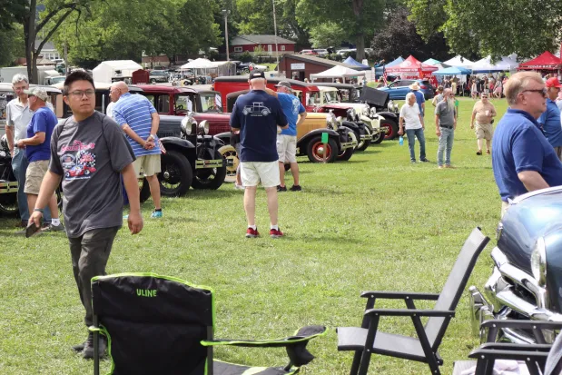 People walk through and inspect rows of cars Sunday, Aug. 2, 2026, at the 63rd annual Das Awkscht Fescht antique and classic car show at Macungie Memorial Park in Macungie. (Jon Chiu/The Morning Call