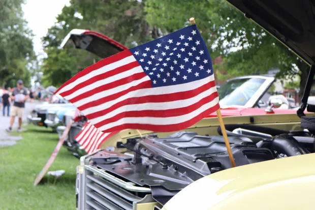 American flags fly from a pair of Oldsmobiles Sunday, Aug. 2, 2026, at the 63rd annual Das Awkscht Fescht antique and classic car show at Macungie Memorial Park in Macungie. (Jon Chiu/The Morning Call)
