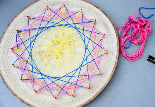 Dakota's finished string art inspired by plants and flowers Monday, Aug. 17, 2026, during Art in the Garden: A Week of Creativity in Easton Urban Farm at the Neighborhood Center in Easton. During the event, children spend their mornings exploring the Easton Urban Farm while creating hands-on art inspired by the world around them.(April Gamiz/The Morning Call)