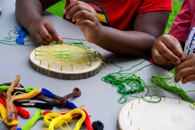 Dakota and Jaxson create string art inspired by plants and flowers Monday, Aug. 17, 2026, during Art in the Garden: A Week of Creativity in Easton Urban Farm at the Neighborhood Center in Easton. During the event, children spend their mornings exploring the Easton Urban Farm while creating hands-on art inspired by the world around them.(April Gamiz/The Morning Call)