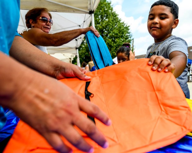 Kaden Santiago, 7, of Allentown chooses a free book bag Saturday, Aug. 8, 2026, during the 9th Annual Back To School Event hosted by Puertorrican Culture Preservation Inc at Buck Boyle Park in Allentown. The event featured 500 free backpacks, snacks and back-to-school supplies given by local organizations. (April Gamiz/The Morning Call)