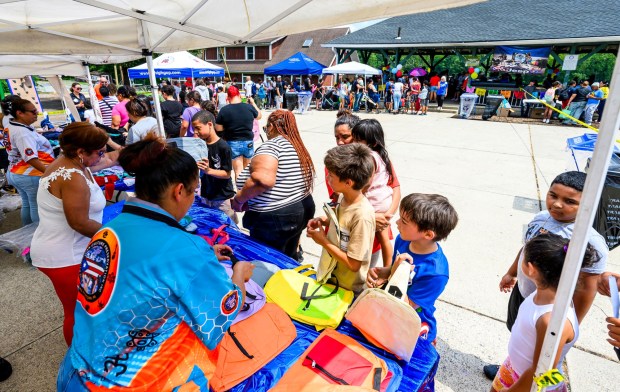 Children choose free backpacks Saturday, Aug. 8, 2026, during the 9th Annual Back To School Event hosted by Puertorrican Culture Preservation Inc at Buck Boyle Park in Allentown. The event featured 500 free backpacks, snacks and back-to-school supplies given by local organizations. (April Gamiz/The Morning Call)