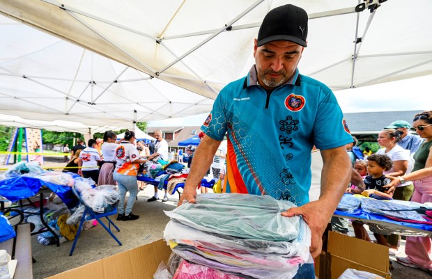 Puertorrican Culture Preservation Inc. member Hector Delgado unpacks hundreds of book bags Saturday, Aug. 8, 2026, during the 9th Annual Back To School Event hosted by Puertorrican Culture Preservation Inc at Buck Boyle Park in Allentown. The event featured 500 free backpacks, snacks and back-to-school supplies given by local organizations. (April Gamiz/The Morning Call)