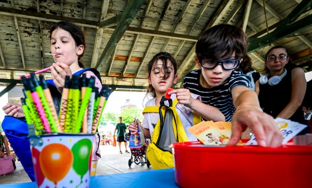 Siblings Juliette Carmen, 8, Able, 10, and Scarlett, 6, choose pencils and erasers from the Allentown Public Library on Saturday, Aug. 8, 2026, during the 9th Annual Back To School Event hosted by Puertorrican Culture Preservation Inc at Buck Boyle Park in Allentown. The event featured 500 free backpacks, snacks and back-to-school supplies given by local organizations. (April Gamiz/The Morning Call)