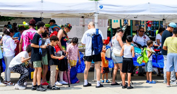 Families enjoy the activities Saturday, Aug. 8, 2026, during the 9th Annual Back To School Event hosted by Puertorrican Culture Preservation Inc at Buck Boyle Park in Allentown. The event featured 500 free backpacks, snacks and back-to-school supplies given by local organizations. (April Gamiz/The Morning Call)