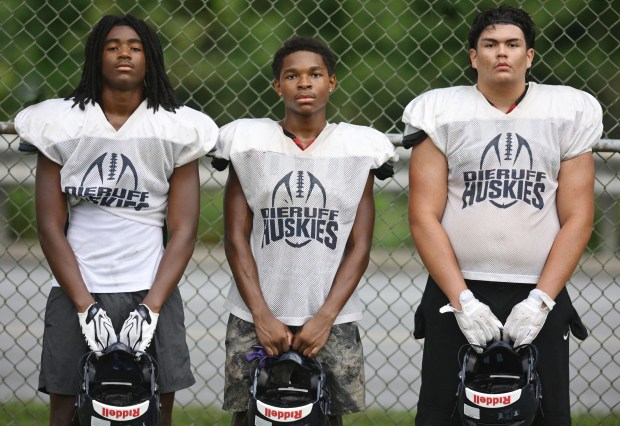 Kory Byrd, left, Kayson Barlow, and Marcus Soto, stand for a picture after the Dieruff football team holds practice Monday, Aug, 10, 2026, on the opening day of the heat acclimatization period. The Huskies practice well away from the school on North 3rd Street in Allentown. (Monica Cabrera/The Morning Call)