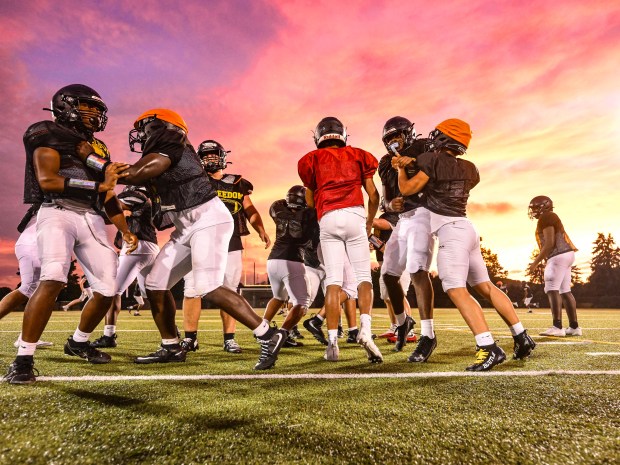 Freedom High School Football players run drills in the evening of Monday, Aug. 17, 2026, during their football practice in Bethlehem. Freedom is coming off a tough season by their standards. The Patriots were 5-6 last season, but are optimistic about staging a turnaround. (Monica Cabrera/The Morning Call)