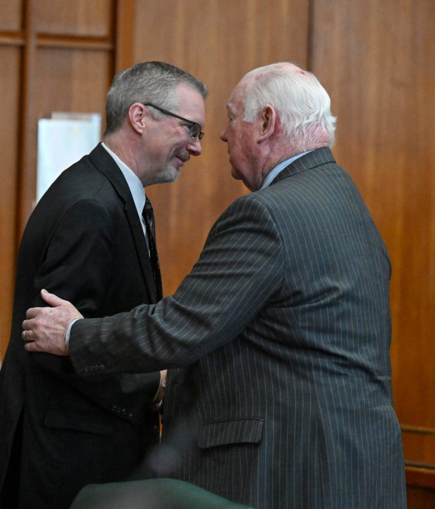 Gavin P. Holihan and Jim Martin shake hands Tuesday, Jan. 2, 2024 after Holihan is sworn in as Lehigh County district attorney by Lehigh County Senior Judge Carol K. McGinley Tuesday, Jan. 2, 2024, at the Lehigh County Courthouse in Allentown. (Monica Cabrera/The Morning Call)