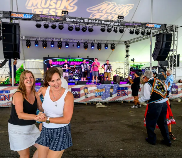 Kim Christian and Jackie Petrie polka Sunday, Aug. 9, 2026, as John Stevens' Doubleshot Polka Band plays at Service Electric Festplatz on the last day of Musikfest in Bethlehem. (April Gamiz/The Morning Call)
