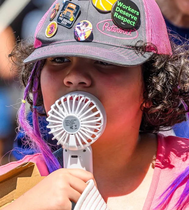 Saharrah Blyskal, 11, tries to keep cool in the afternoon heat with a portable fan Sunday, Aug. 9, 2026, on the last day of Musikfest in Bethlehem. (April Gamiz/The Morning Call)