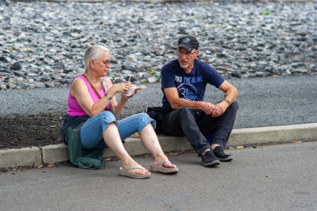 Festivalgoers enjoy food, music, and the atmosphere as they gather ahead of the evening's headlining performance during Musikfest on Sunday, Aug. 2, 2026, in Bethlehem. The annual festival runs through Aug. 9. (Jonathan Broady/Special to The Morning Call)