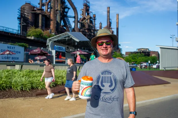 Festivalgoers enjoy food, music, and the atmosphere as they gather ahead of the evening's headlining performance during Musikfest on Monday, Aug. 3, 2026, in Bethlehem. The annual festival runs through Aug. 9. (Jonathan Broady/Special to The Morning Call)