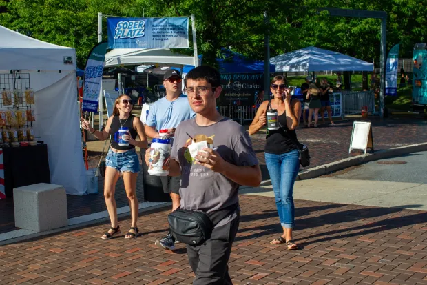 Festivalgoers enjoy food, music, and the atmosphere as they gather ahead of the evening's headlining performance during Musikfest on Monday, Aug. 3, 2026, in Bethlehem. The annual festival runs through Aug. 9. (Jonathan Broady/Special to The Morning Call)