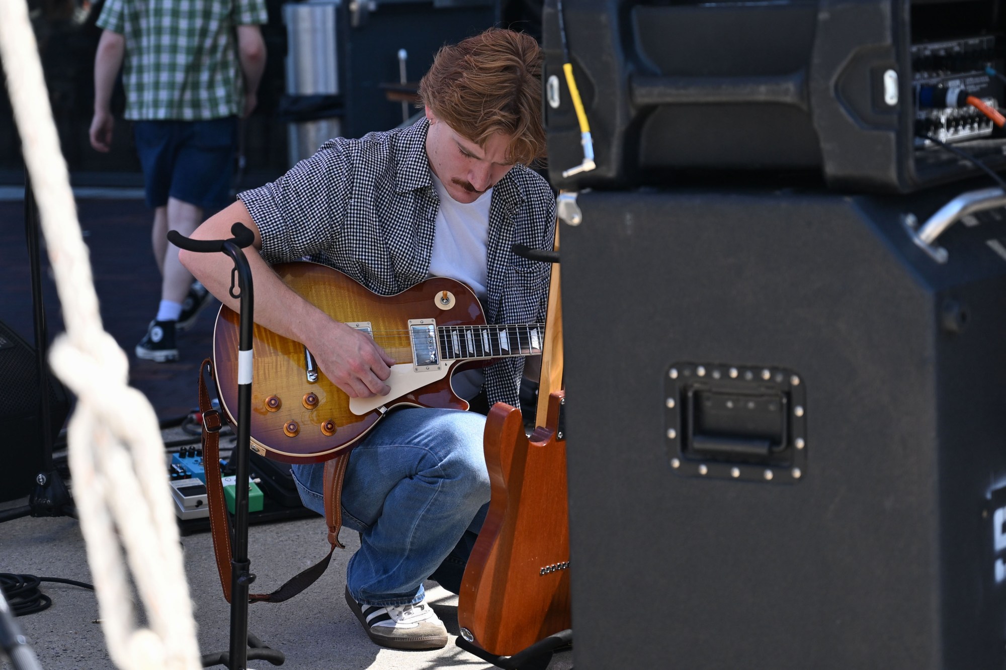 Travis Brown of Bethlehem inspects a guitar ahead of The Swell's performance at Musikfest Tuesday, Aug. 4, 2026, at the SteelStacks in Bethlehem. (Jon Chiu/The Morning Call)