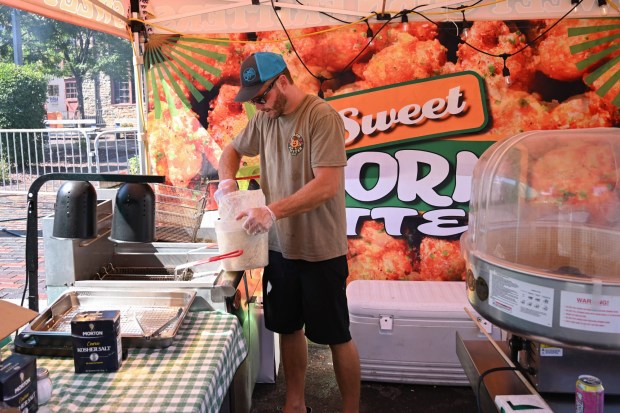 Zach Vimstead of Bangor prepares his corn fritter stand for festivalgoers during Musikfest Tuesday, Aug. 4, 2026, at the SteelStacks in Bethlehem. (Jon Chiu/The Morning Call)