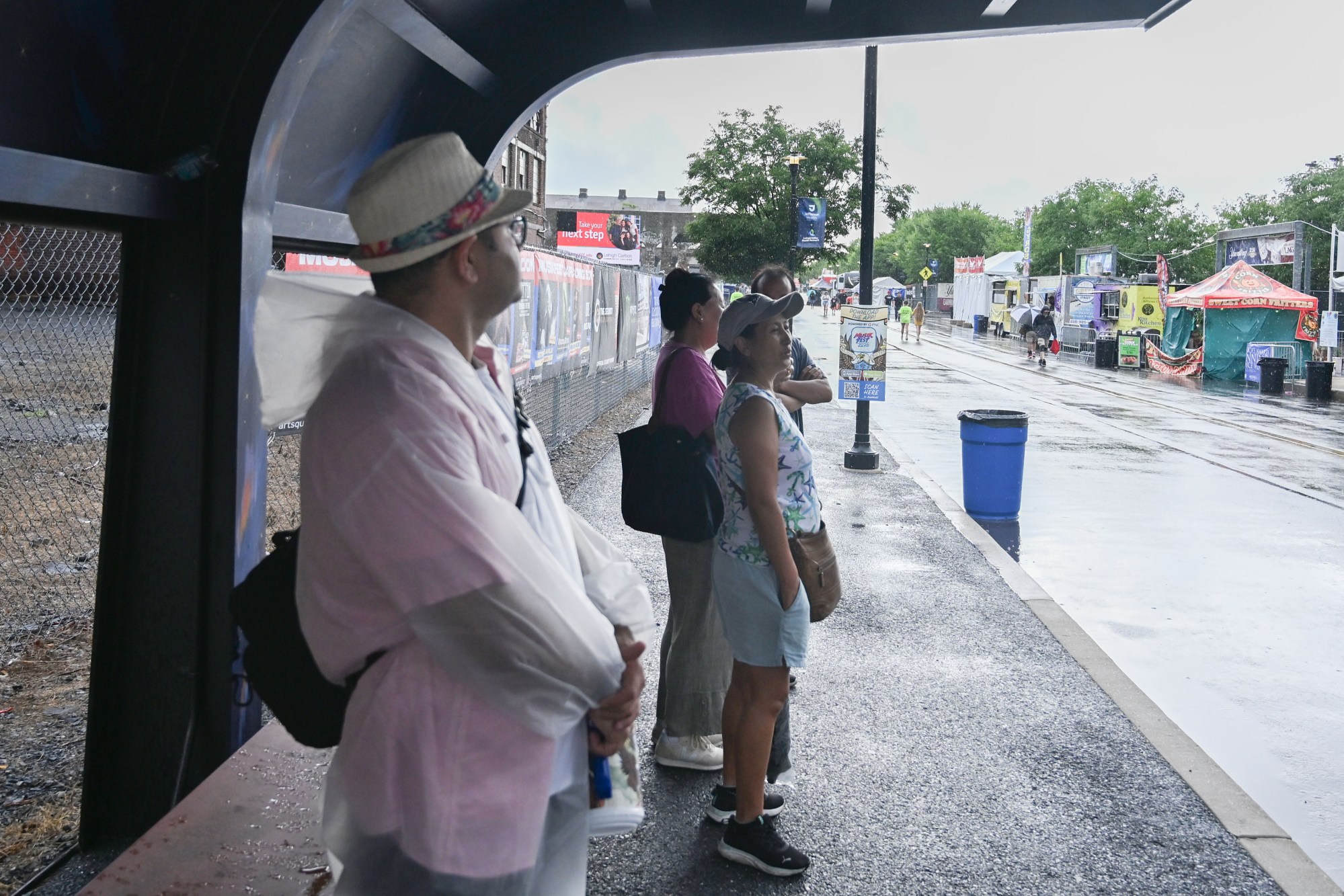 People wait out the rain from a passing a storm during Musikfest on Friday, Aug. 7, 2026, at the SteelStacks in Bethlehem. (Jon Chiu/The Morning Call)