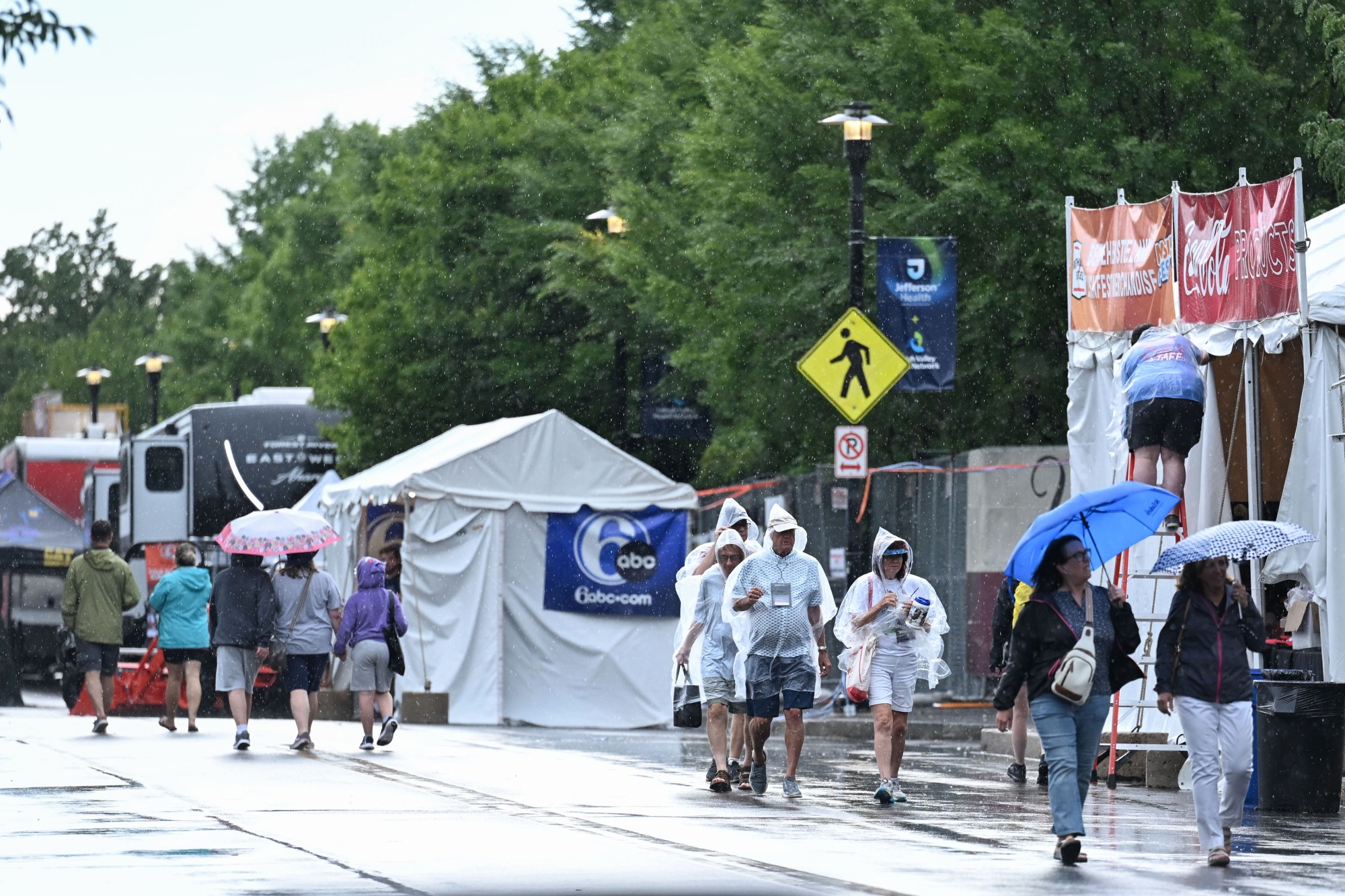 People walk around Musikfest following its temporary shutdown by a passing storm on Friday, Aug. 7, 2026, at the SteelStacks in Bethlehem. (Jon Chiu/The Morning Call)