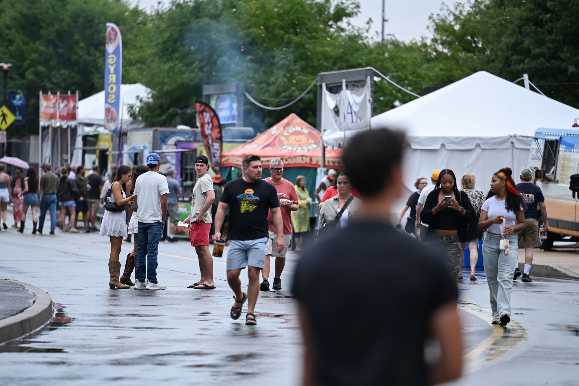 People walk around Musikfest following its temporary shutdown by a passing storm on Friday, Aug. 7, 2026, at the SteelStacks in Bethlehem. (Jon Chiu/The Morning Call)