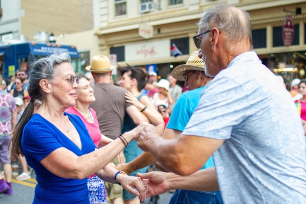 Festivalgoers enjoy food, music, and the atmosphere as they gather ahead of the evening's headlining performance during Musikfest on Saturday, Aug. 8, 2026, in Bethlehem. The annual festival runs through Aug. 9. (Jonathan Broady/Special to The Morning Call)