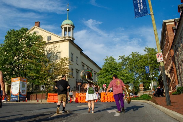 Festivalgoers enjoy food, music, and the atmosphere as they gather ahead of the evening's headlining performance during Musikfest on Saturday, Aug. 8, 2026, in Bethlehem. The annual festival runs through Aug. 9. (Jonathan Broady/Special to The Morning Call)